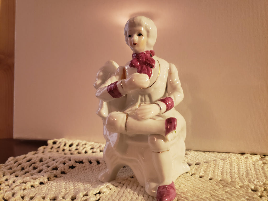 Porcelain Figurine of a man seating