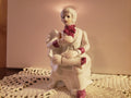 Porcelain Figurine of a man seating